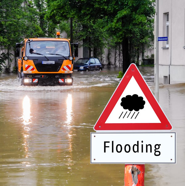 Image of flooding incident, with vehicle driving through deep water.