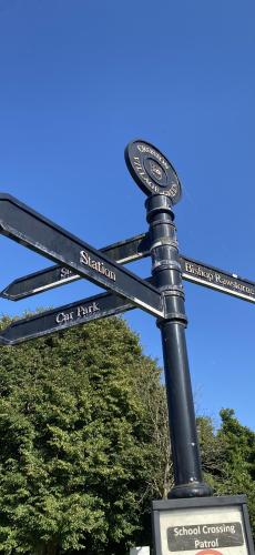 Signpost on The Green BEFORE renovation August 2024 